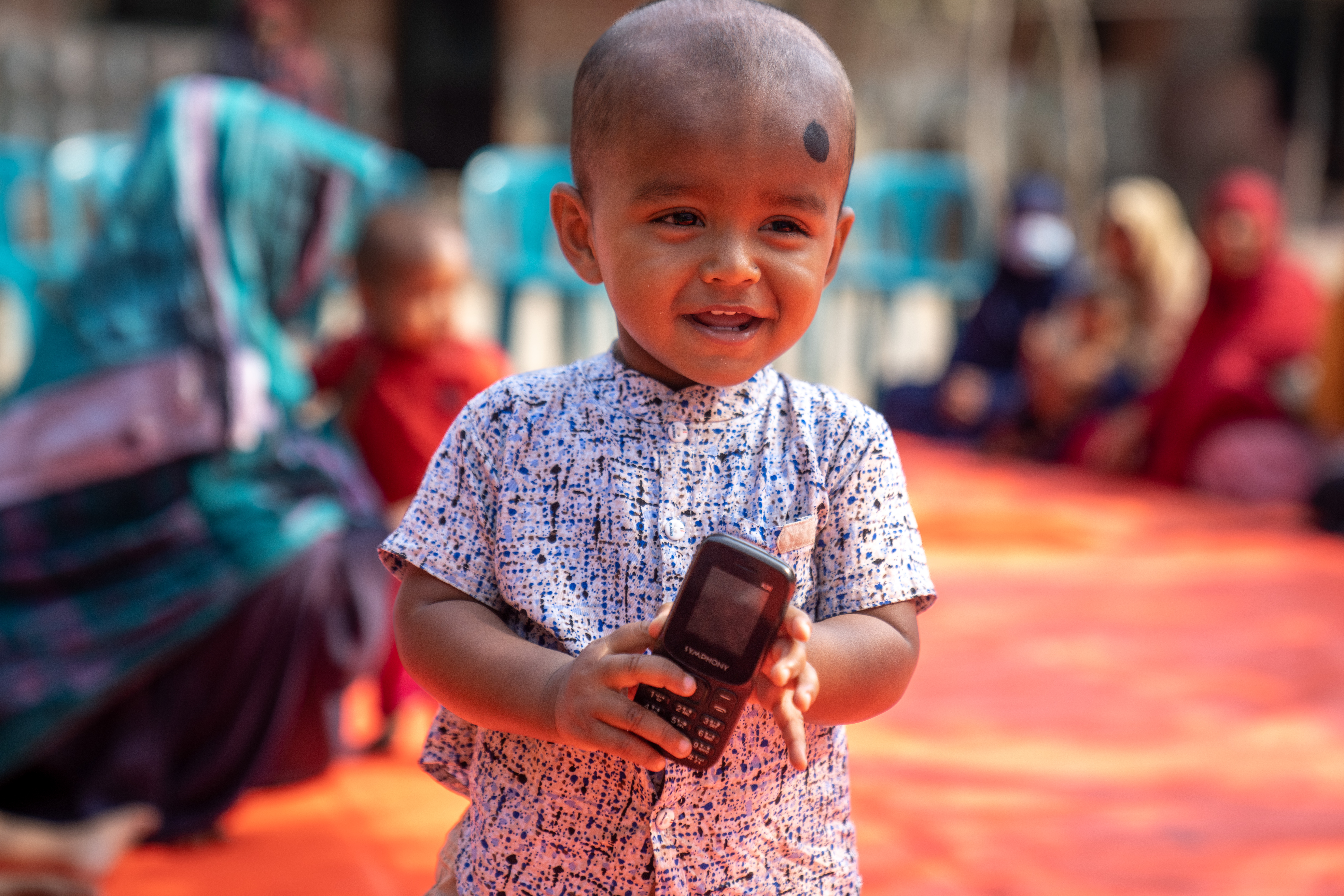 A smiling child at a community health gathering in Barisal District